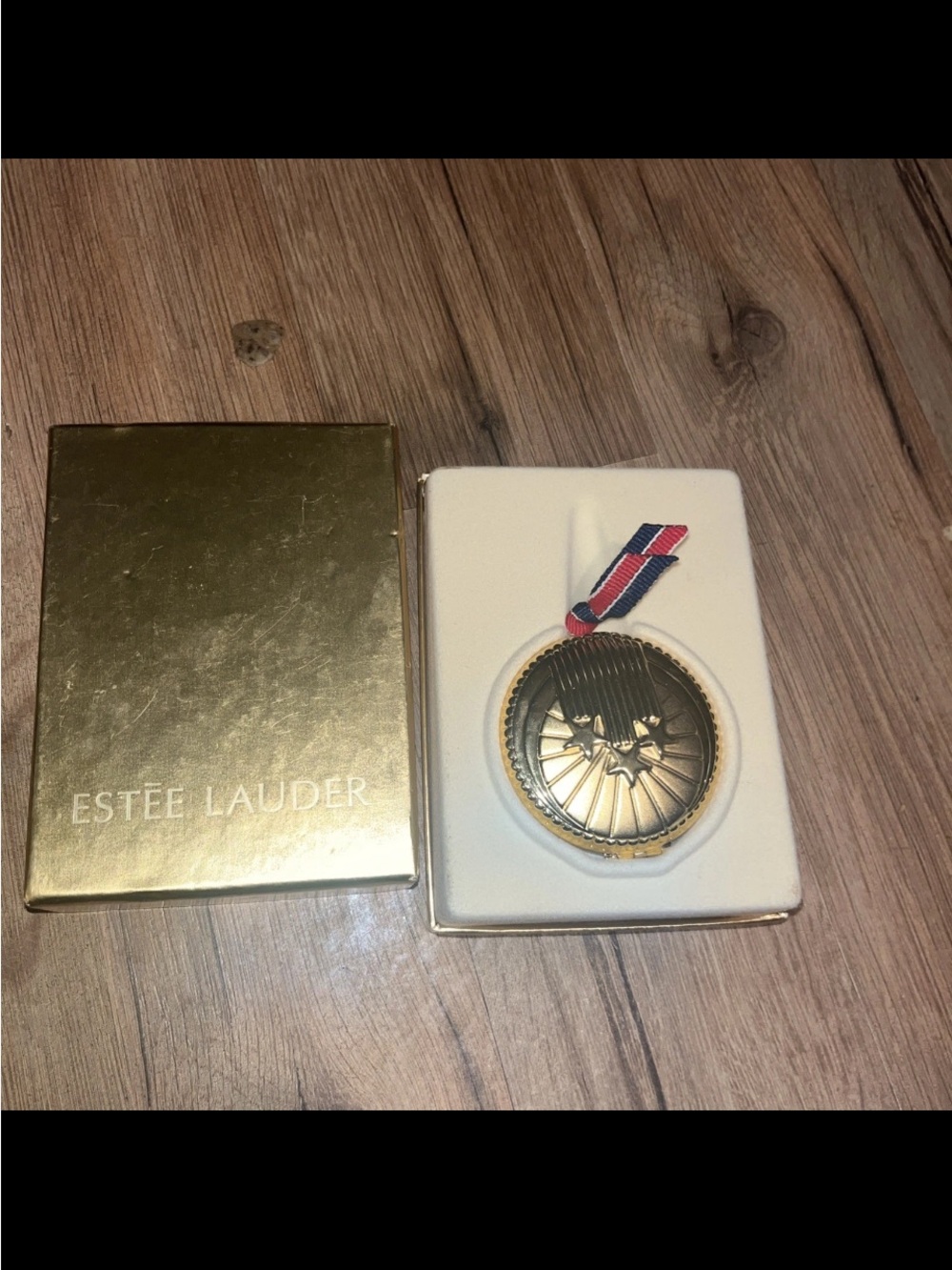 Estee Lauder Gold Medallion Ornament with Red-Blue Ribbon